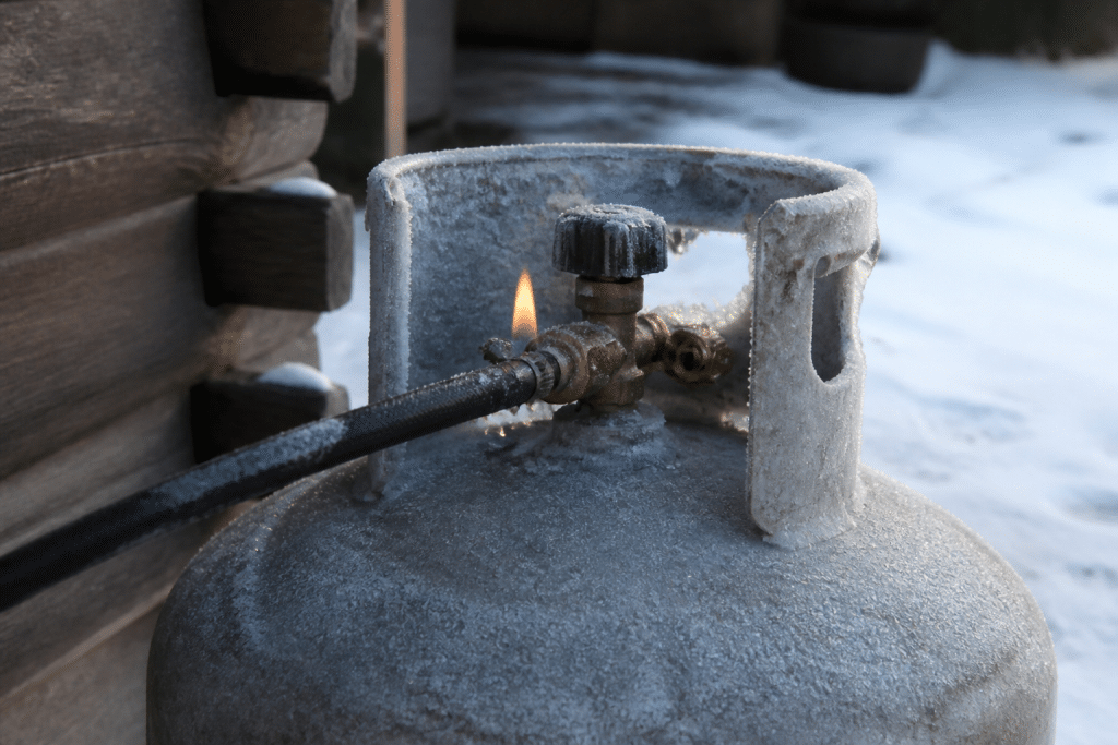 Bouteille de gaz gelée affichant flamme faible hivernal