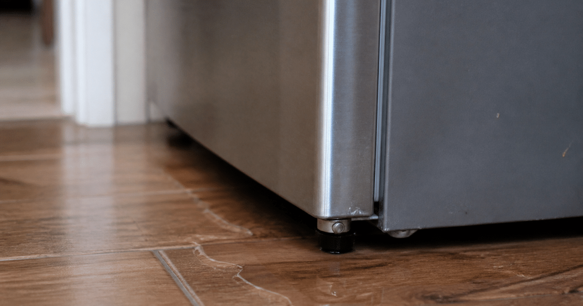 Refrigerator with water pooling beneath its base